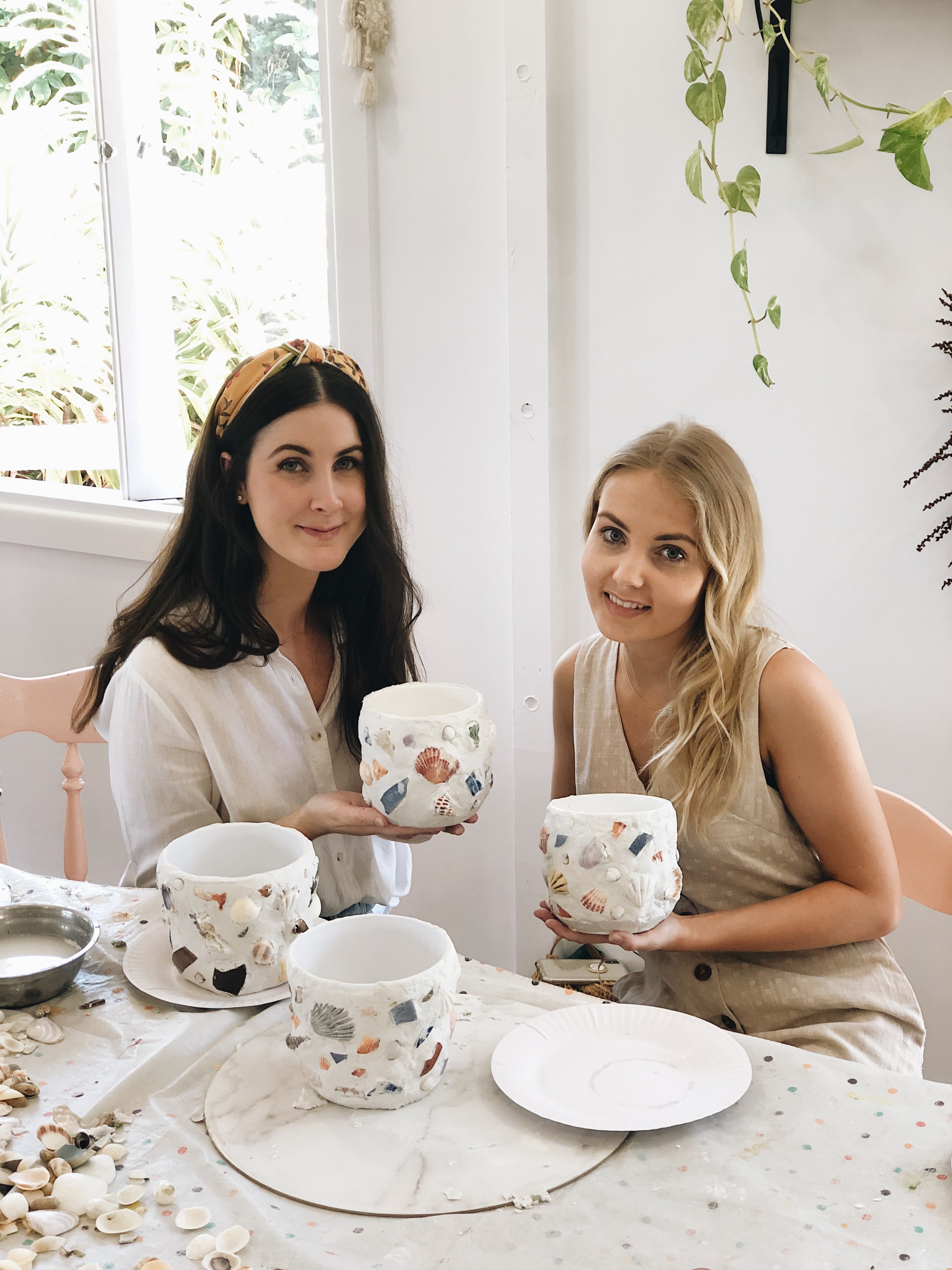 Two girls with their finished shell mosaic pots at The Craft Parlour