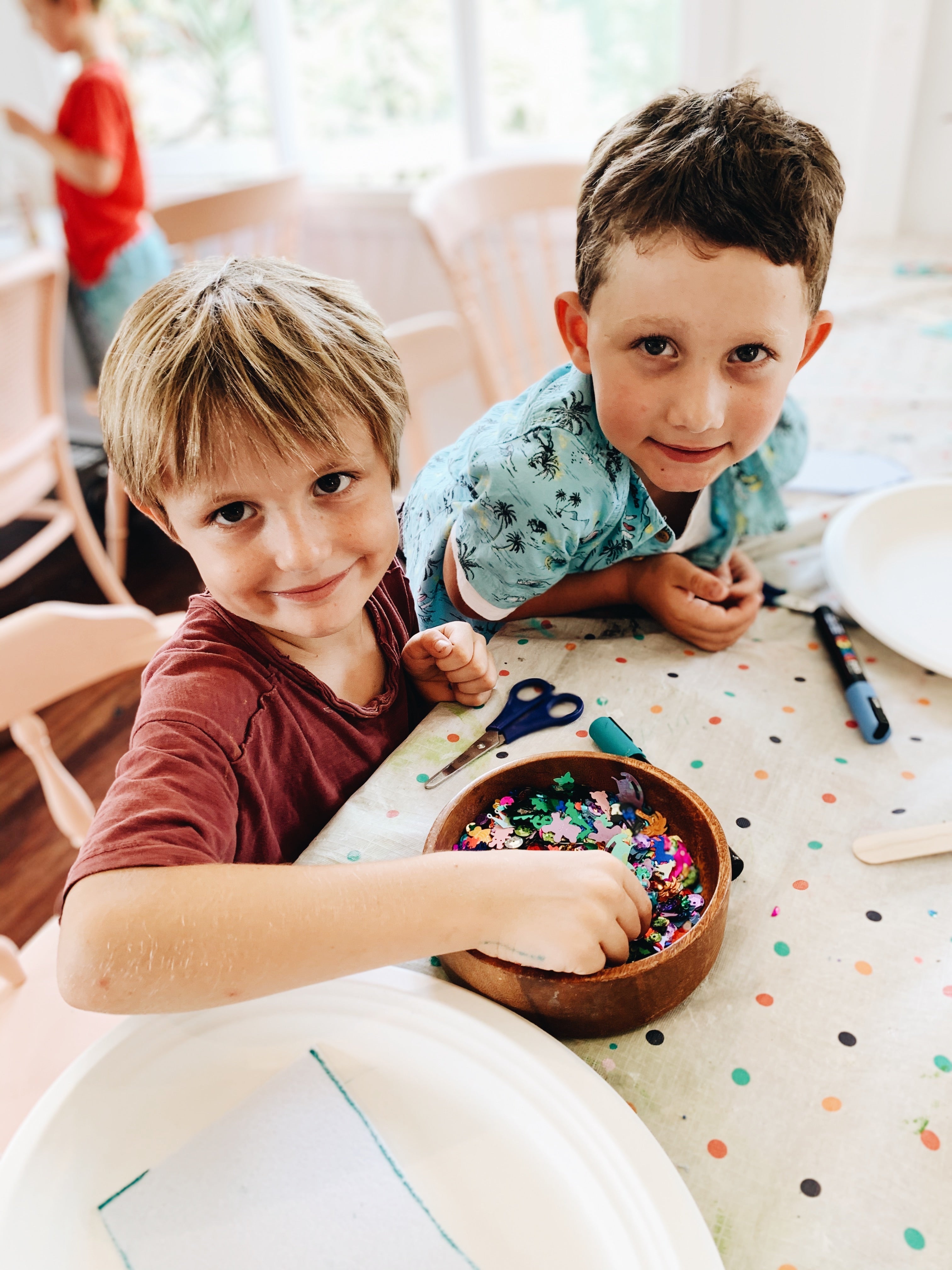 Two young boys making craft at after school craft club