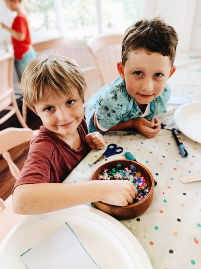 Two young boys making craft at after school craft club