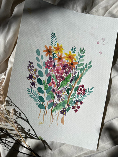 Watercolor painting of a floral bouquet on a textured surface