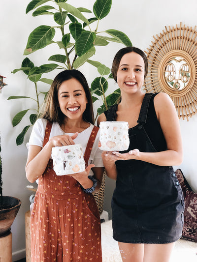 Two girls with their finished shell mosaic pots at Gold Coast workshop