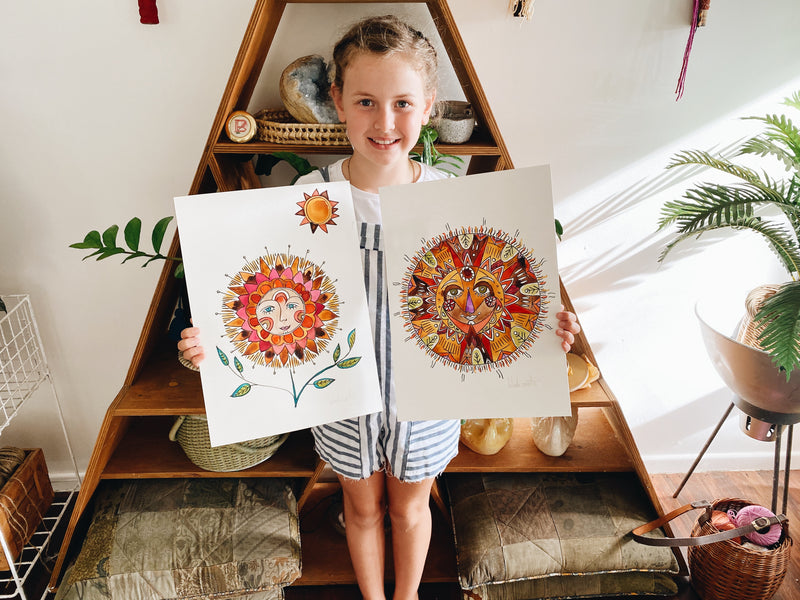 Girl with her colourful summer solstice paintings at The Craft Parlour workshop