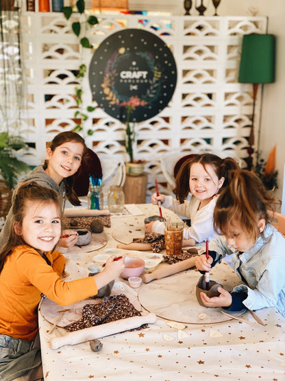Four children making handmade animal pottery during kids pottery class Gold Coast