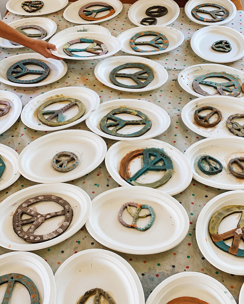 Handmade peace signs drying at Gold Coast kids pottery class