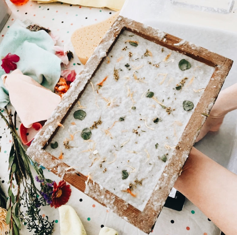 Handmade paper setting in a wooden frame made with flowers and leaves